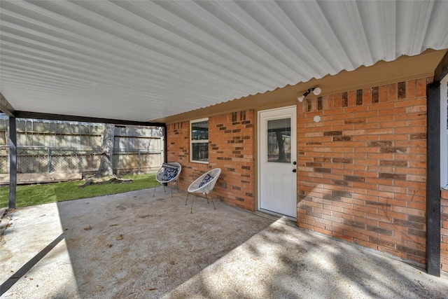 view of patio featuring fence