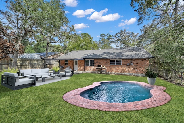 rear view of property featuring an outdoor hangout area, a yard, a patio, and a fenced backyard