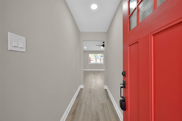 hall featuring recessed lighting, light wood finished floors, and baseboards