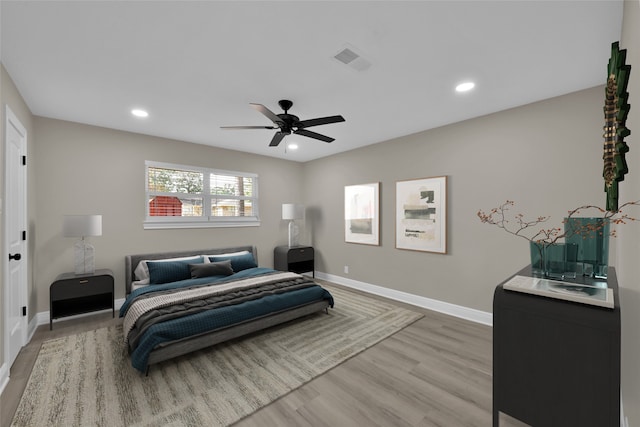 bedroom with baseboards, recessed lighting, visible vents, and light wood-style floors