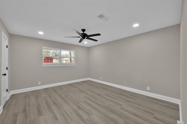 spare room with visible vents, recessed lighting, light wood-style flooring, and baseboards