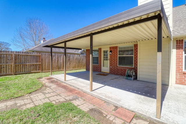 view of patio / terrace featuring a carport and fence