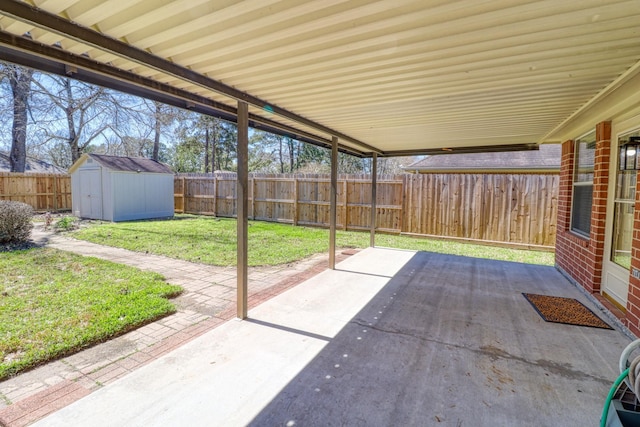 view of patio / terrace featuring a fenced backyard, an outdoor structure, and a shed