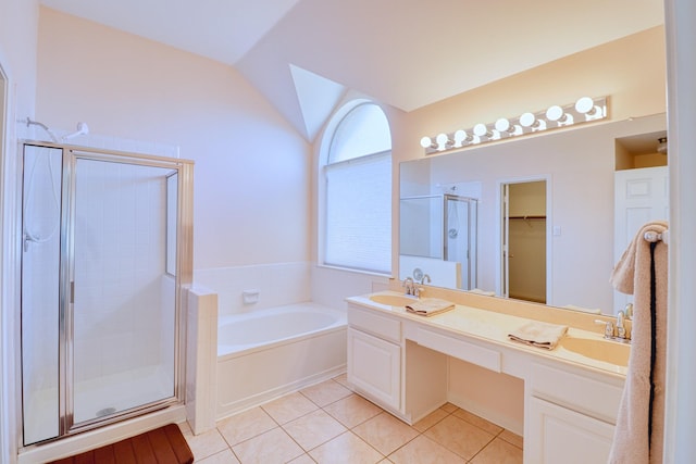 full bath with lofted ceiling, a stall shower, a bath, tile patterned floors, and a sink