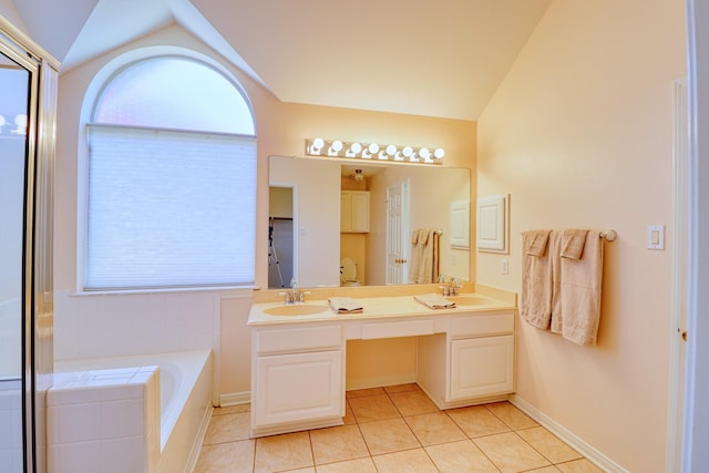 full bathroom with tile patterned flooring, a sink, and vaulted ceiling