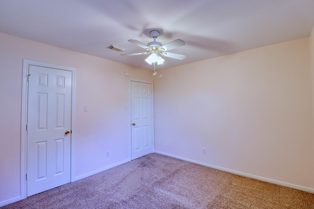 empty room with visible vents, baseboards, ceiling fan, and carpet flooring