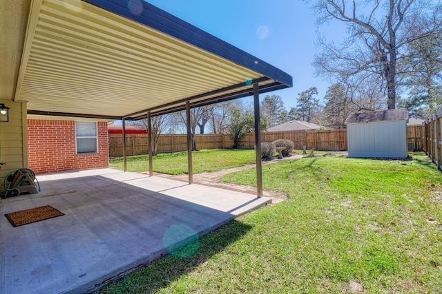 view of yard with a fenced backyard, a shed, an outdoor structure, a carport, and a patio area