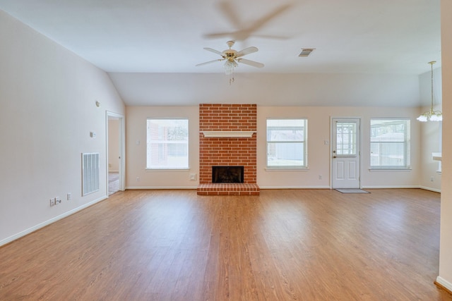 unfurnished living room featuring visible vents, plenty of natural light, and wood finished floors