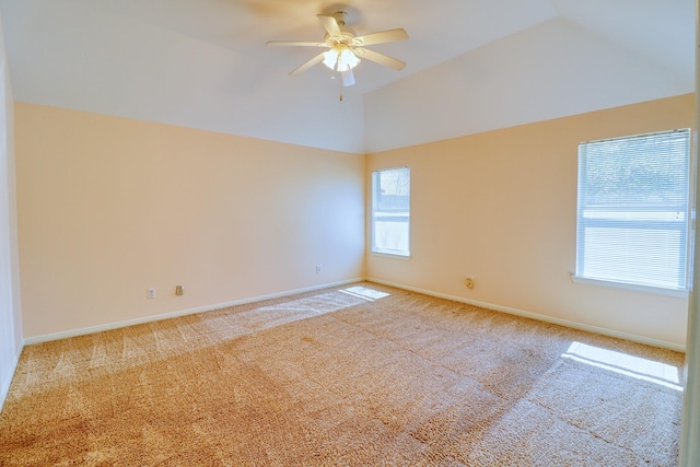 empty room with ceiling fan, baseboards, carpet, and vaulted ceiling