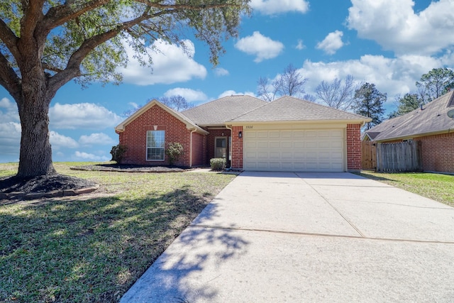 ranch-style house featuring a front yard, brick siding, concrete driveway, and an attached garage