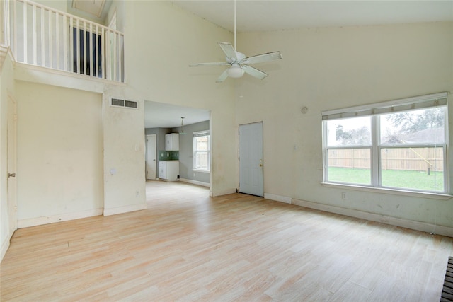 unfurnished living room with baseboards, ceiling fan, visible vents, and wood finished floors