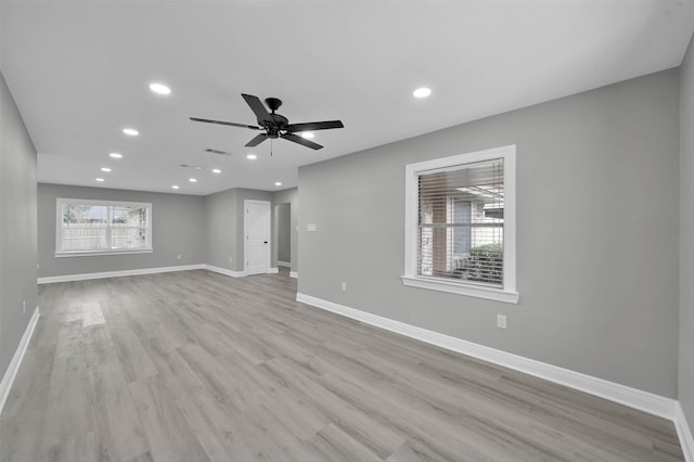 unfurnished living room with recessed lighting, visible vents, ceiling fan, wood finished floors, and baseboards