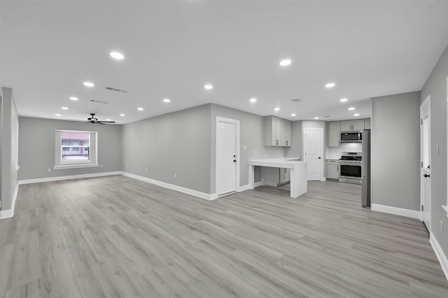 unfurnished living room with baseboards and recessed lighting