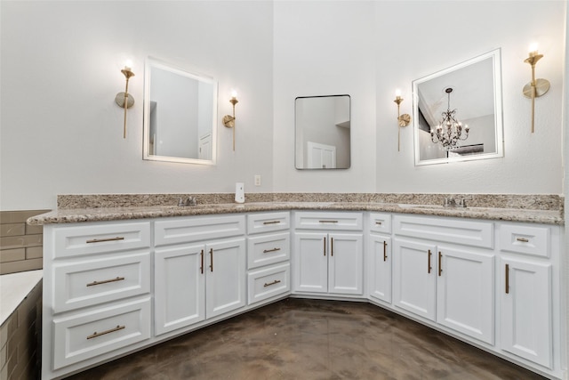 full bath featuring double vanity, concrete floors, a chandelier, and a sink