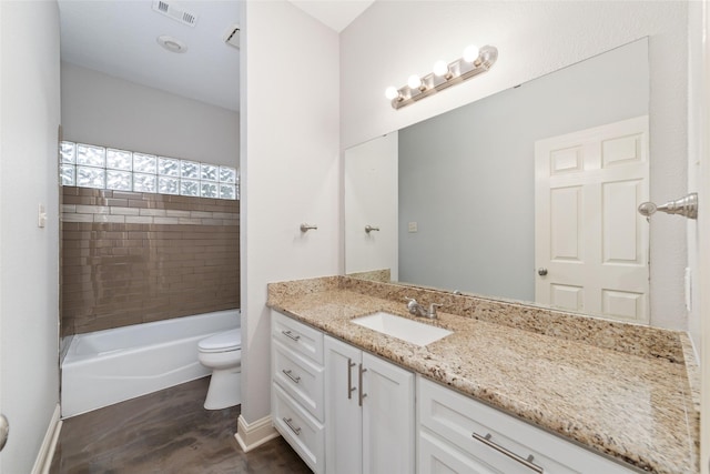 bathroom featuring toilet, baseboards, visible vents, and vanity