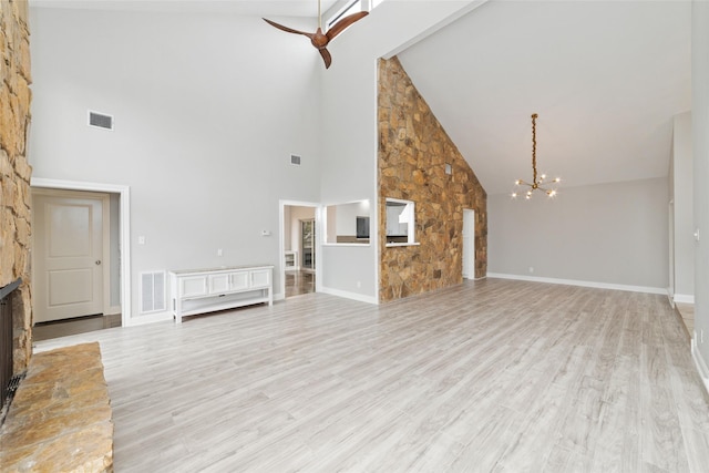 unfurnished living room featuring light wood-style flooring, a fireplace, and visible vents