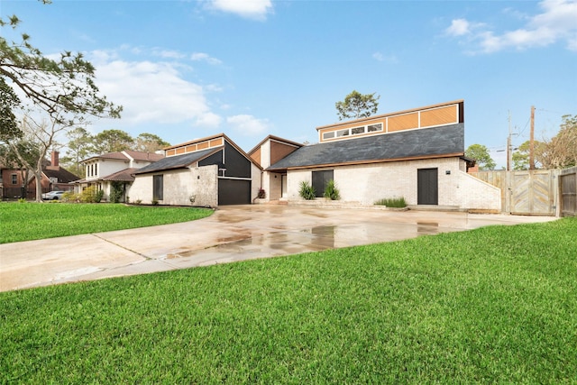 view of front of property with driveway, a front lawn, an attached garage, and fence