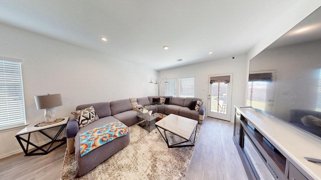 living area featuring light wood finished floors, baseboards, and recessed lighting