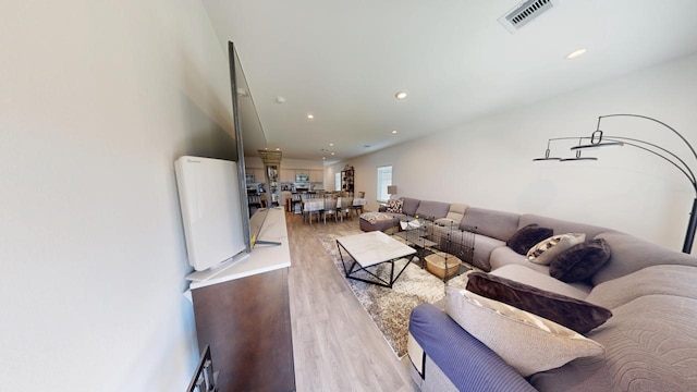 living area featuring visible vents, wood finished floors, and recessed lighting