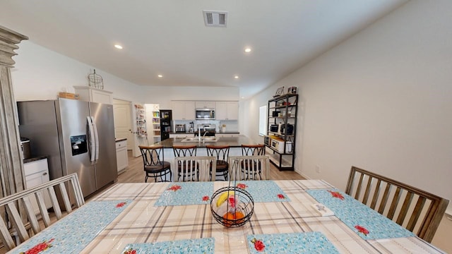 dining room featuring light wood-style floors, visible vents, and recessed lighting