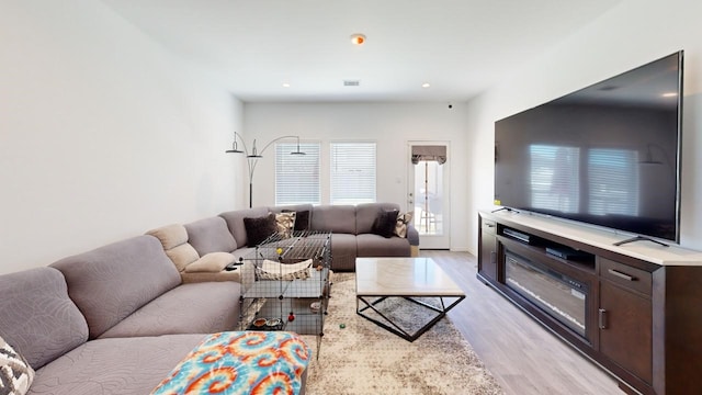 living room featuring light wood finished floors and recessed lighting