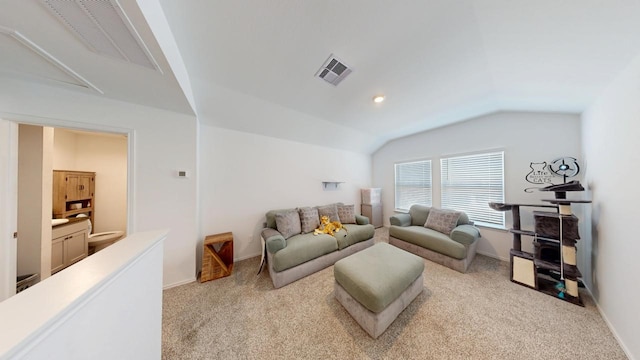 living area with lofted ceiling, visible vents, light carpet, and baseboards