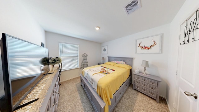 bedroom featuring light colored carpet, visible vents, and baseboards