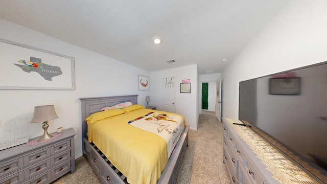 bedroom featuring visible vents and light colored carpet