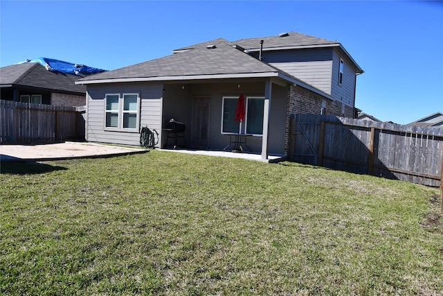 rear view of house featuring a patio area, a lawn, a fenced backyard, and brick siding