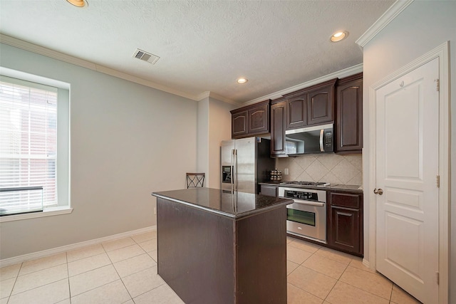 kitchen with stainless steel appliances, dark brown cabinets, light tile patterned flooring, and backsplash