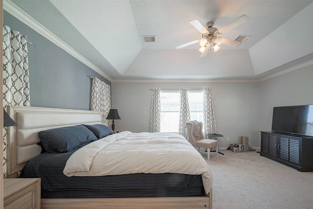 carpeted bedroom with lofted ceiling, ceiling fan, a raised ceiling, and visible vents