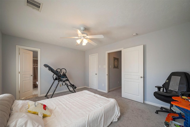 carpeted bedroom with a ceiling fan, visible vents, and baseboards