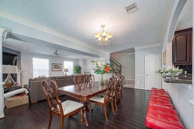 dining area featuring a wainscoted wall, ornamental molding, dark wood finished floors, and visible vents