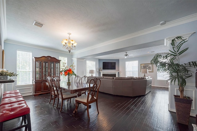 dining space featuring a wealth of natural light, visible vents, dark wood-type flooring, and ornamental molding