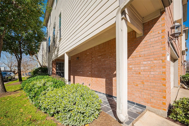 view of property exterior with brick siding