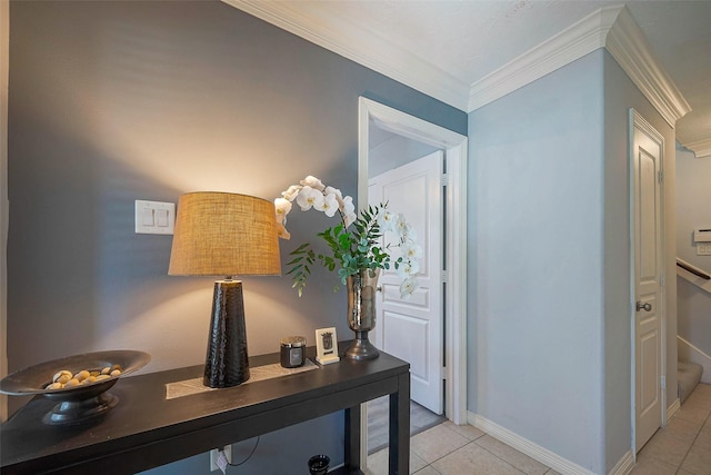 hall with light tile patterned floors, baseboards, and crown molding