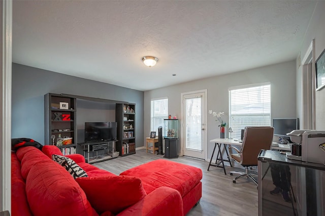 living room with a textured ceiling and wood finished floors