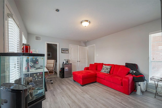 living room with visible vents and wood finished floors