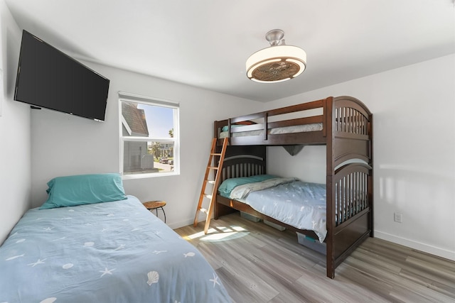 bedroom featuring wood finished floors and baseboards