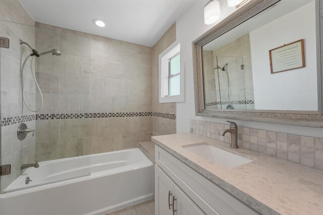 full bathroom featuring bathtub / shower combination, backsplash, and vanity