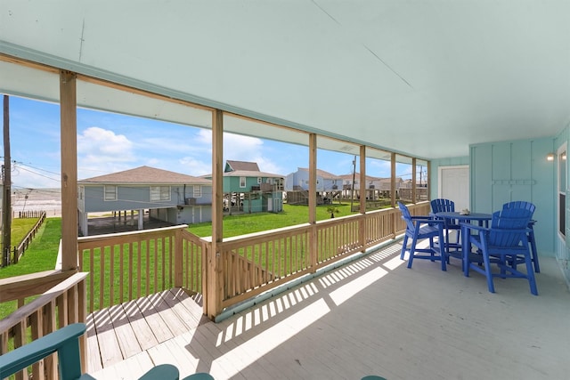 sunroom with a residential view and plenty of natural light