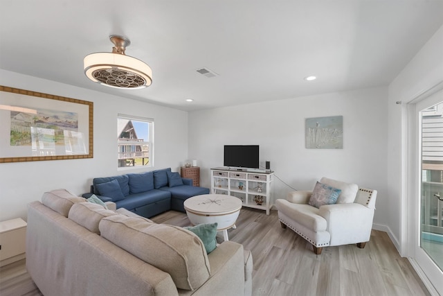 living room featuring recessed lighting, visible vents, and light wood finished floors