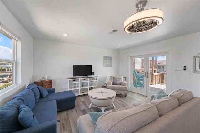 living room featuring recessed lighting, visible vents, wood finished floors, and french doors