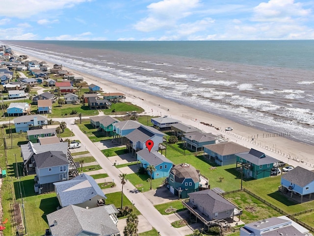 drone / aerial view with a beach view, a residential view, and a water view