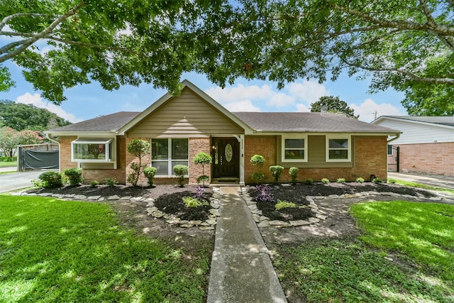 ranch-style house with brick siding and a front yard