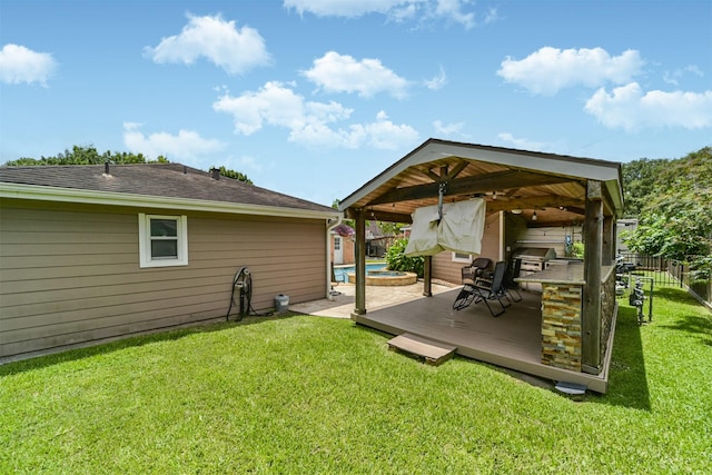 view of yard featuring a gazebo, fence, and a wooden deck