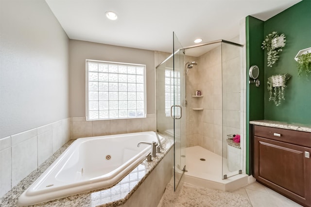 bathroom featuring tile patterned flooring, a shower stall, a jetted tub, and recessed lighting