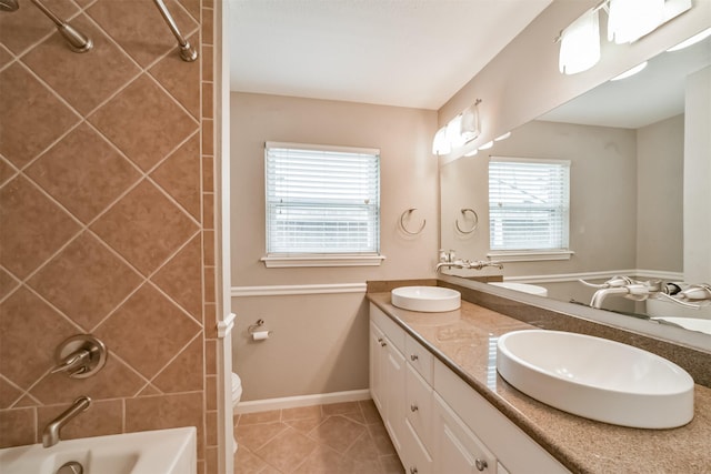 full bathroom featuring tile patterned flooring, tub / shower combination, baseboards, double vanity, and a sink