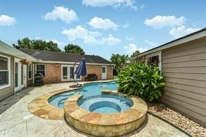 outdoor pool featuring an in ground hot tub and a patio