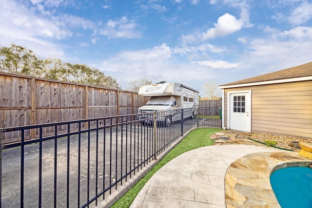 view of patio featuring a fenced in pool and a fenced backyard